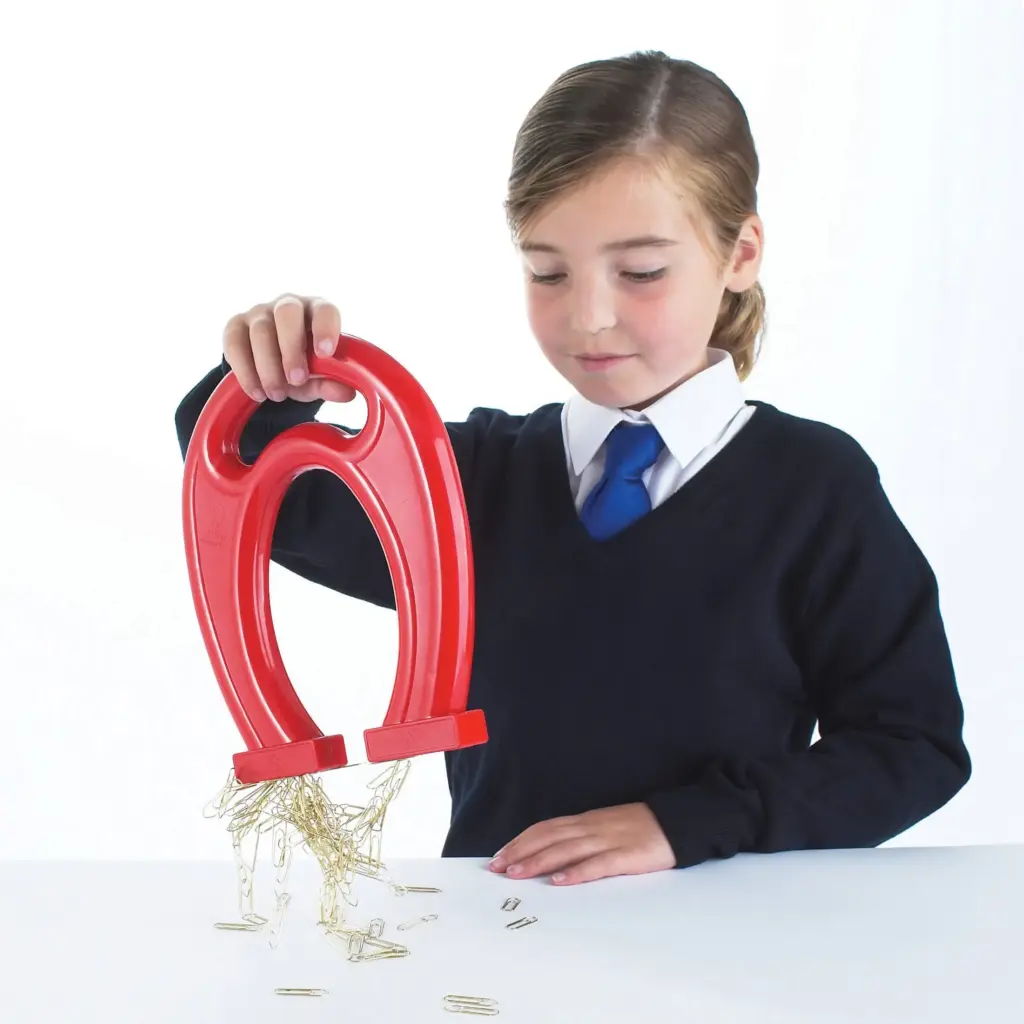 Students using horseshoe educational magnets in a classroom physics experiment